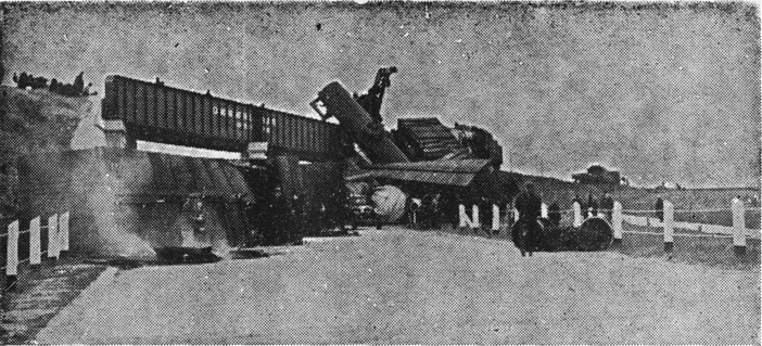 [Freight Cars Plunge to Highway]