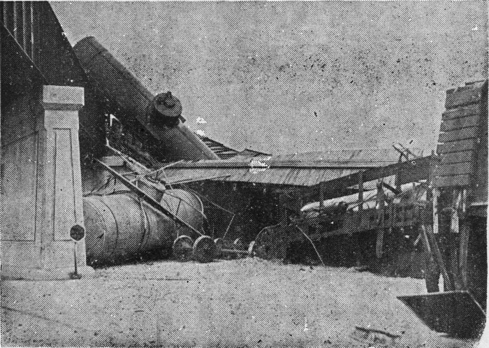 [Freight Cars Plunge to Highway]